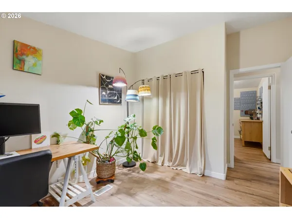 a living room with furniture and a potted plant