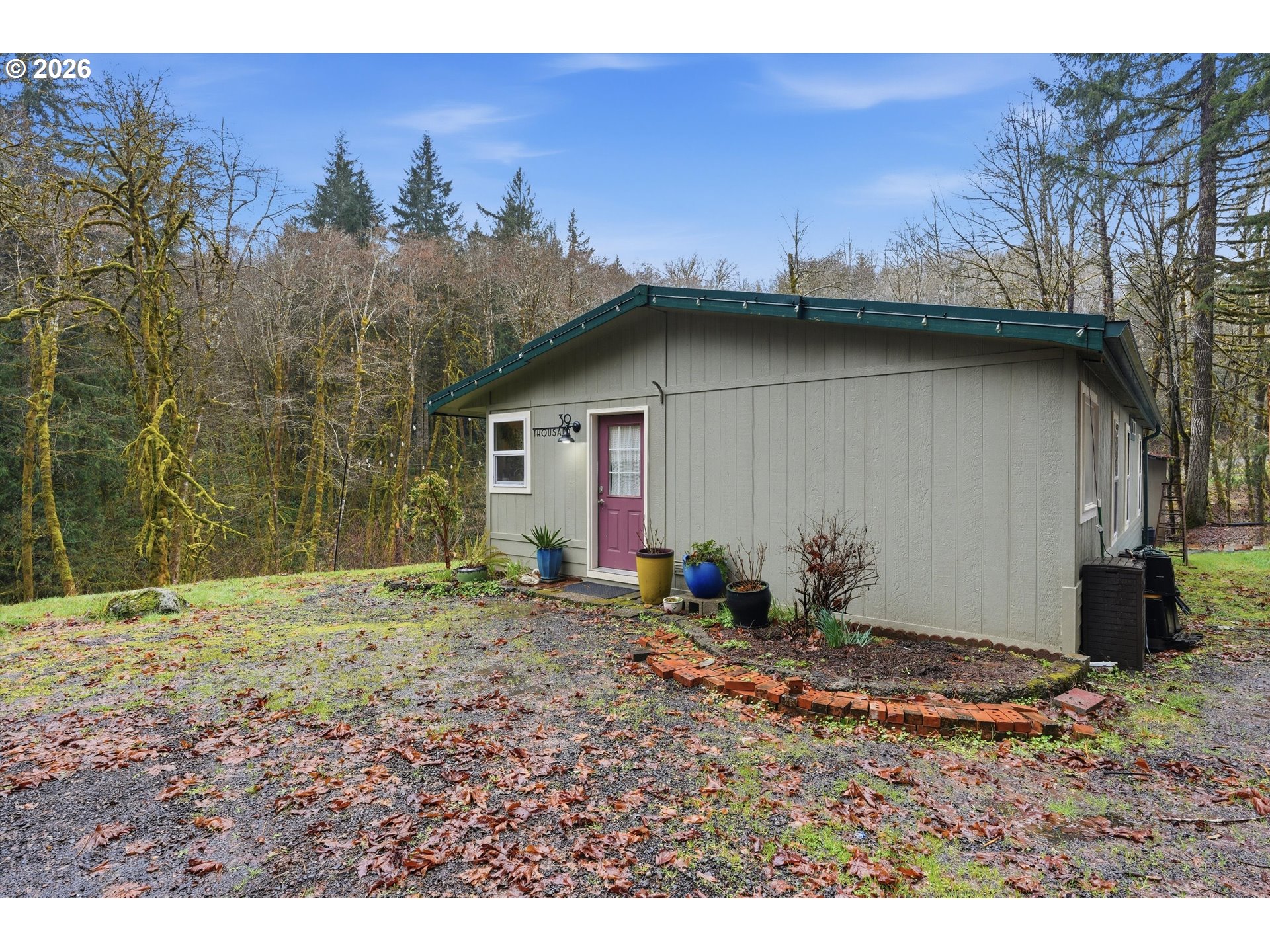 39000 Northwest Shermans Mill Road Banks, OR 97106 - Photo 32 of 38 a backyard of a house with a yard and garage