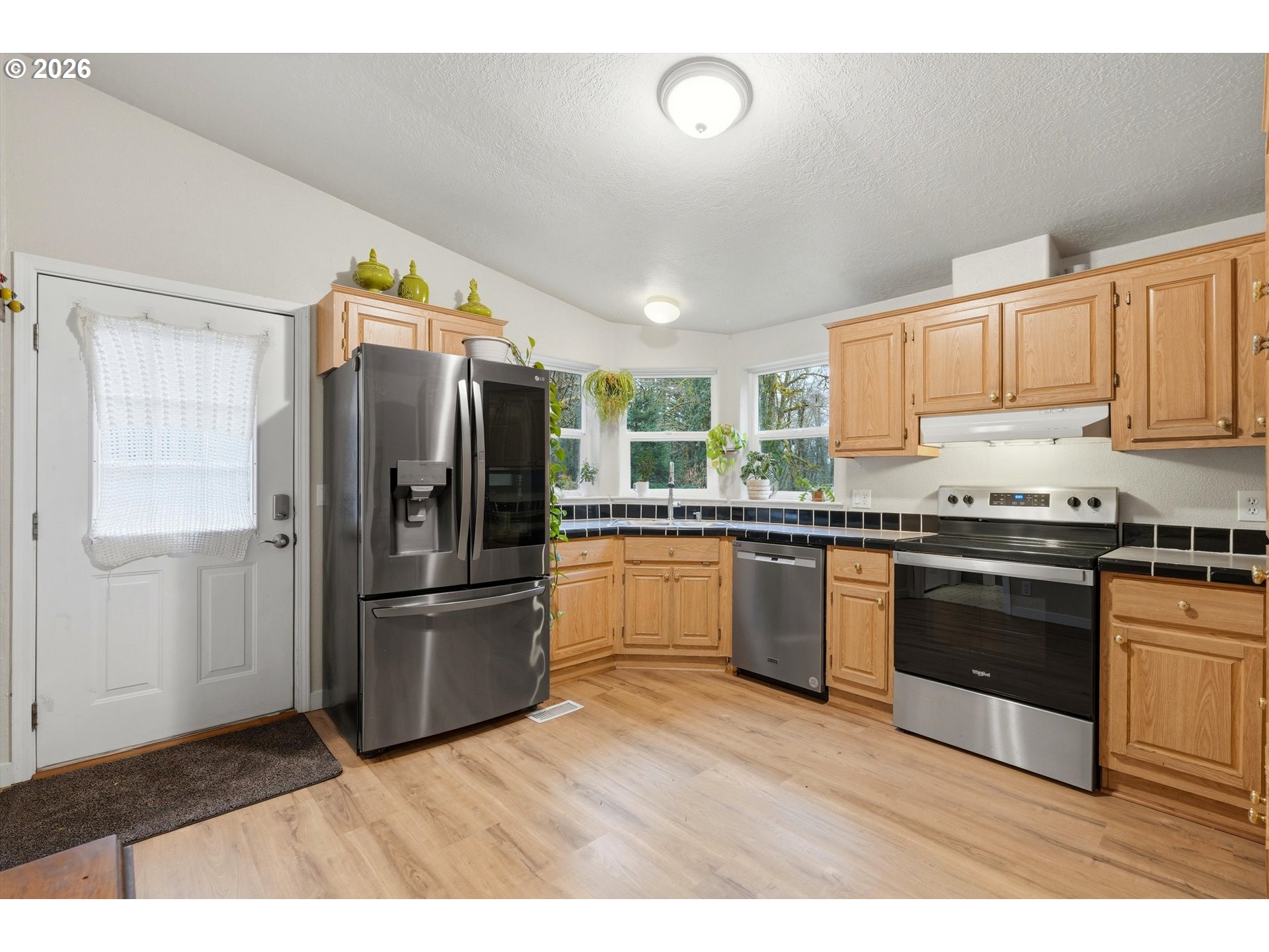 39000 Northwest Shermans Mill Road Banks, OR 97106 - Photo 9 of 38 a kitchen with granite countertop a refrigerator and a stove top oven