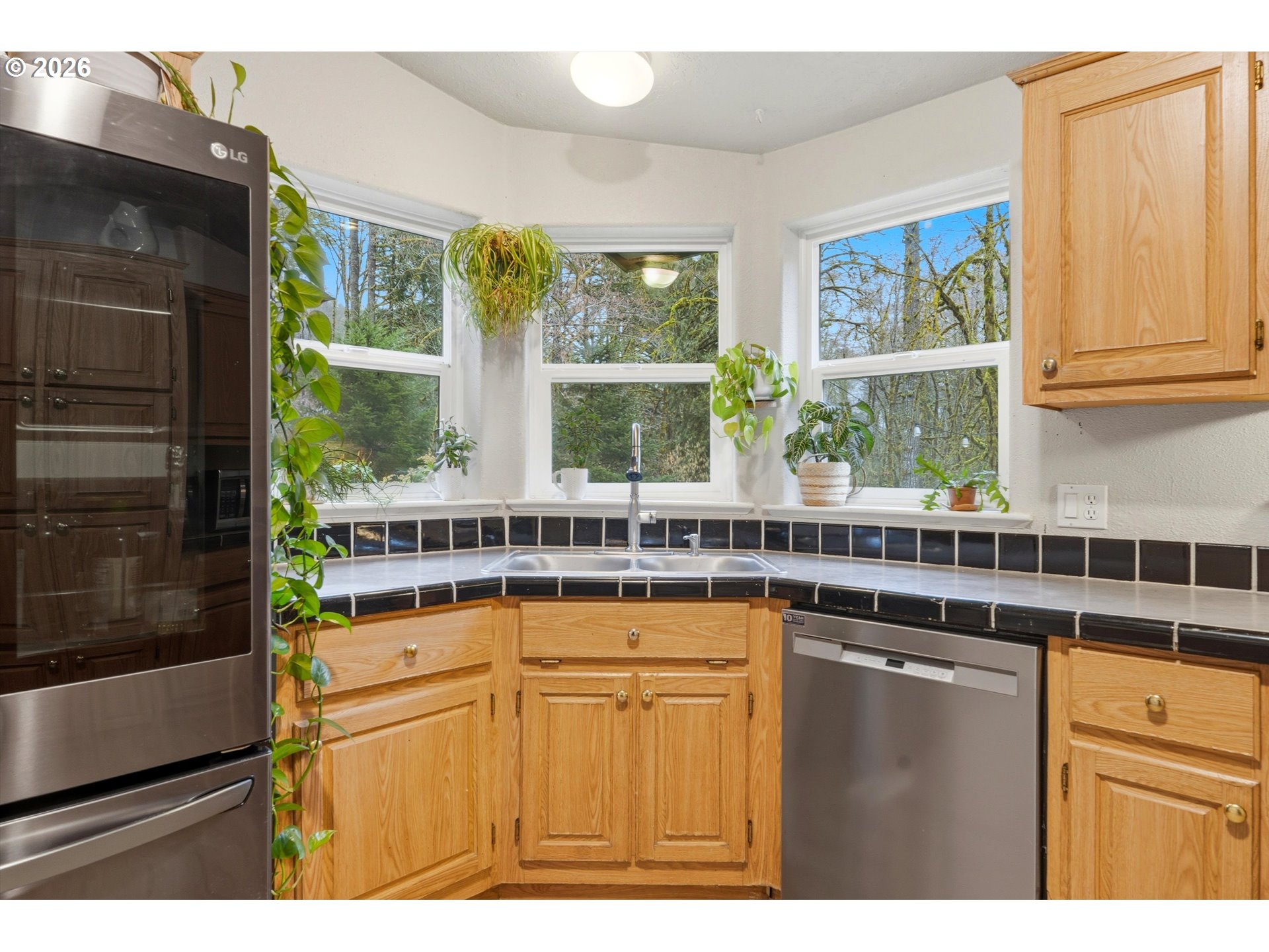 39000 Northwest Shermans Mill Road Banks, OR 97106 - Photo 10 of 38 a kitchen with stainless steel appliances granite countertop a stove and a refrigerator
