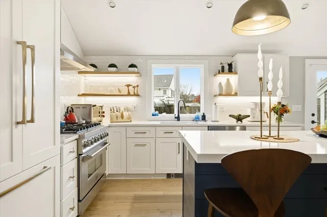 a kitchen with a sink stools a counter space and cabinets
