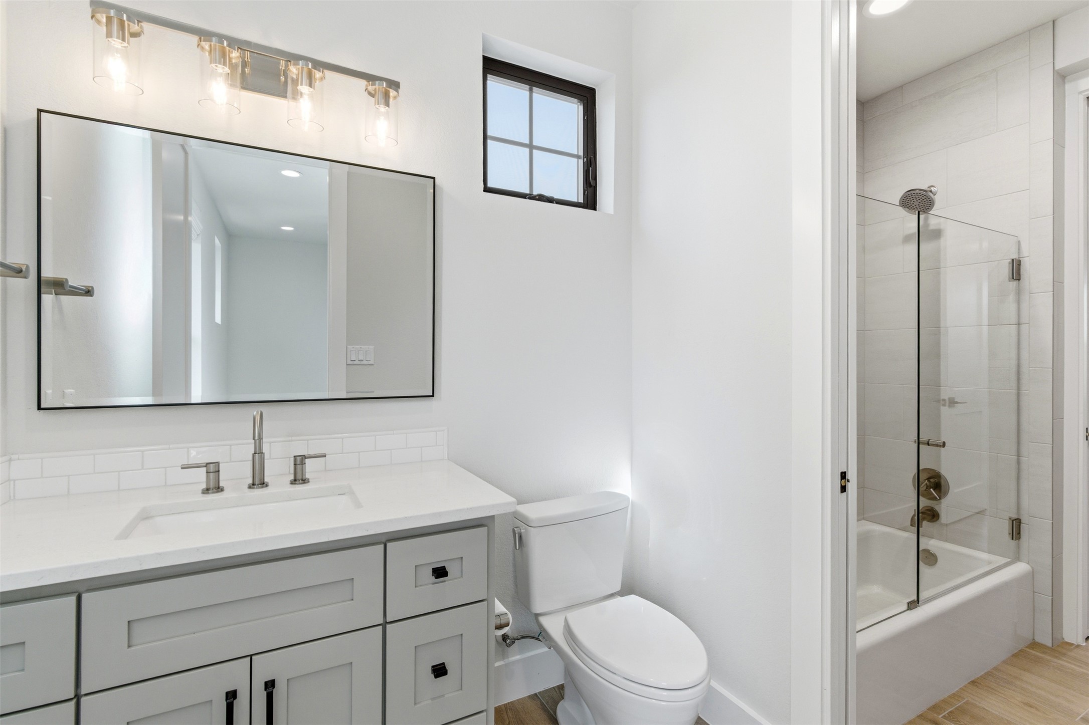 27619 Sunset Loop Garden Ridge, TX 78266 - Photo 19 of 39 Clean lines and modern finishes define this sleek bathroom featuring a glass-enclosed tub.