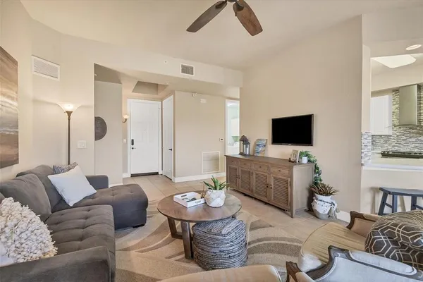 a kitchen with a table chairs refrigerator and cabinets