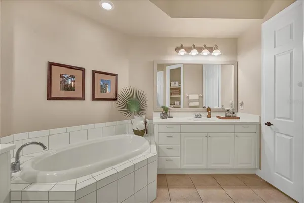 a bedroom with two beds and painting on the wall