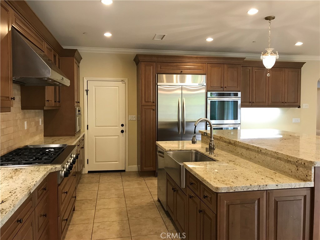 51 Domani Irvine, CA 92618 - Photo 5 of 8 a kitchen with granite countertop a sink stove and cabinets