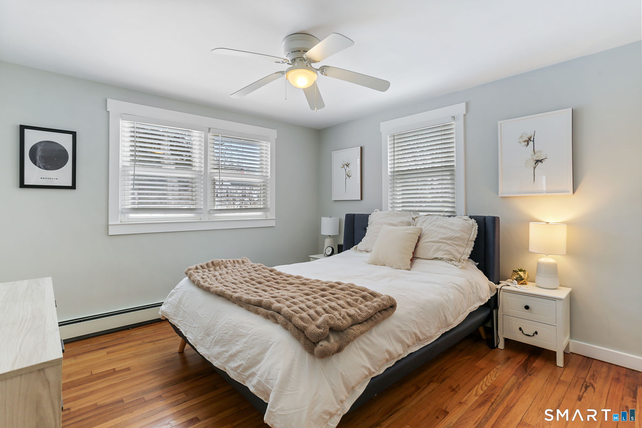 1353 Mill Plain Road Fairfield, CT 06824 - Photo 12 of 37 a bedroom with a bed and a chandelier