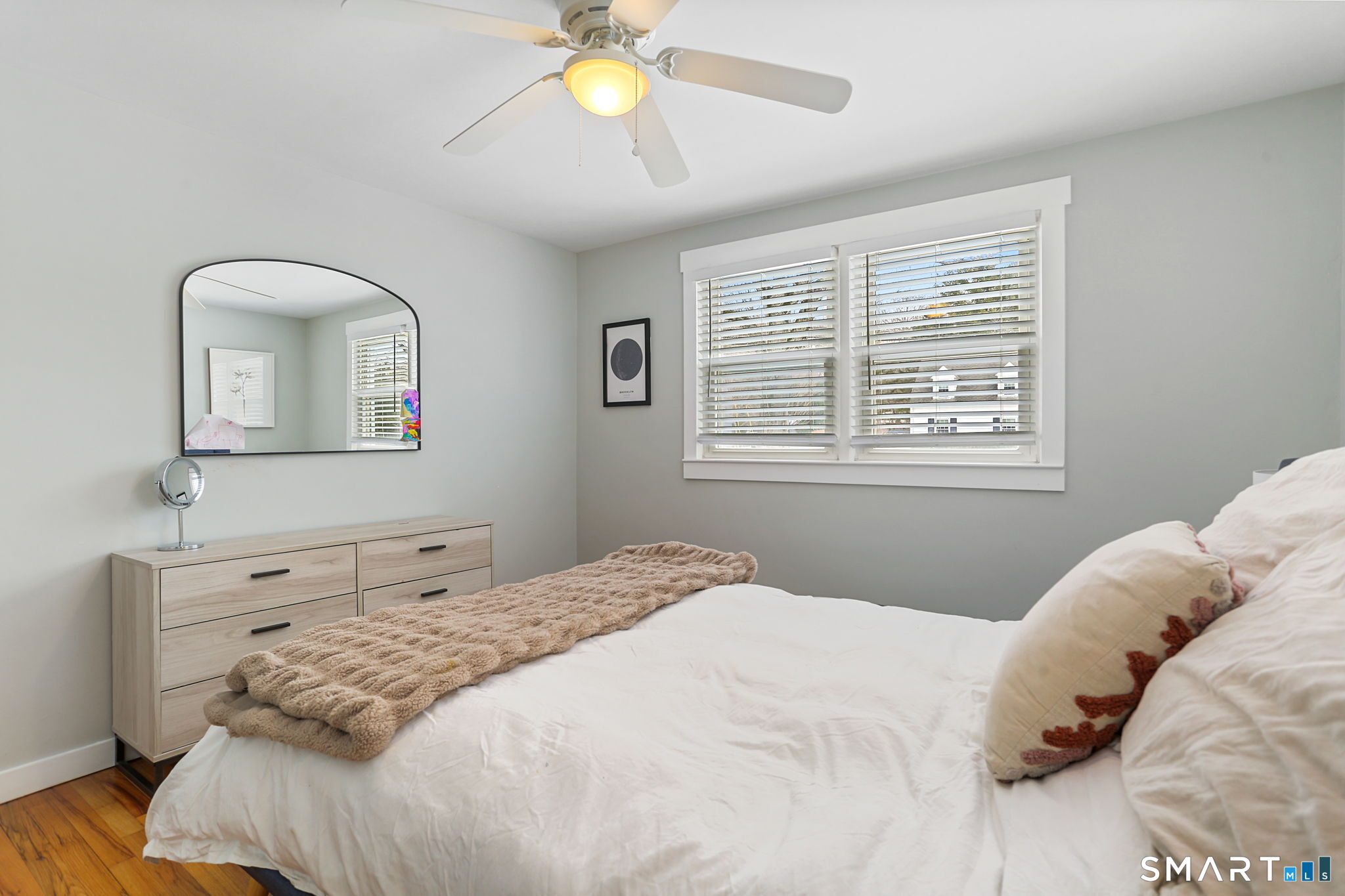 1353 Mill Plain Road Fairfield, CT 06824 - Photo 13 of 37 a bedroom with a bed and a chandelier