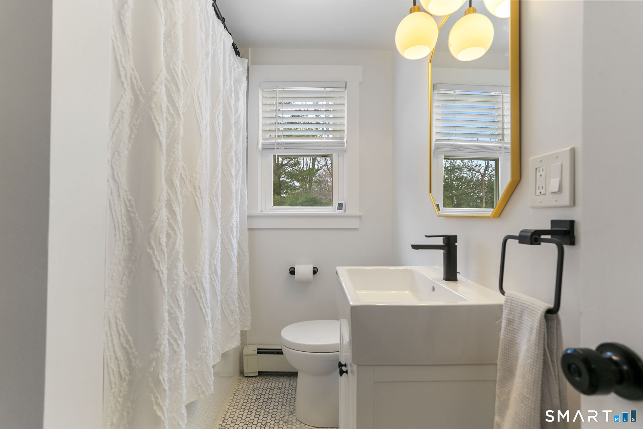 1353 Mill Plain Road Fairfield, CT 06824 - Photo 14 of 37 a bathroom with a sink a toilet and a window