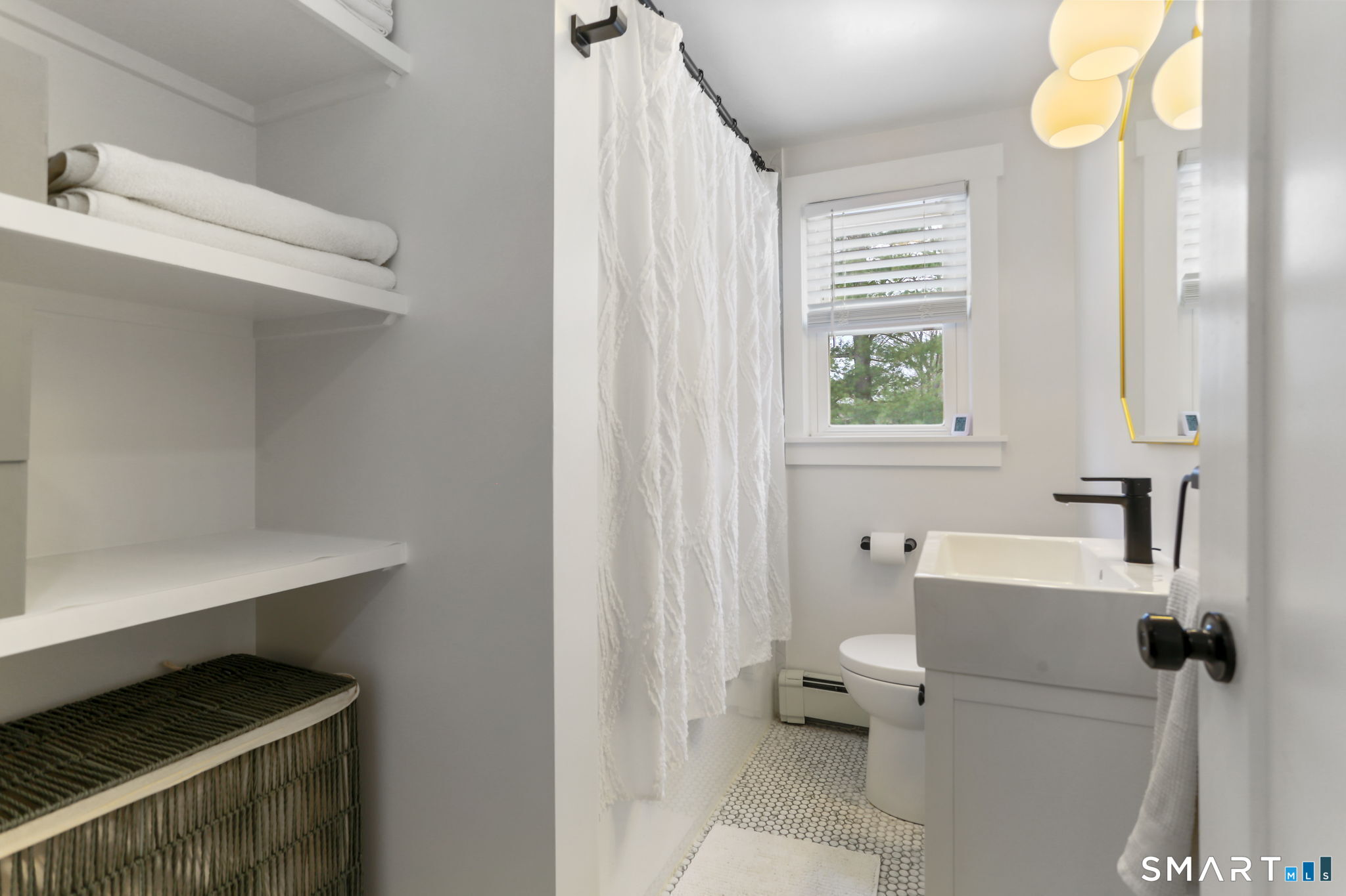 1353 Mill Plain Road Fairfield, CT 06824 - Photo 15 of 37 a bathroom with a sink a toilet and a window