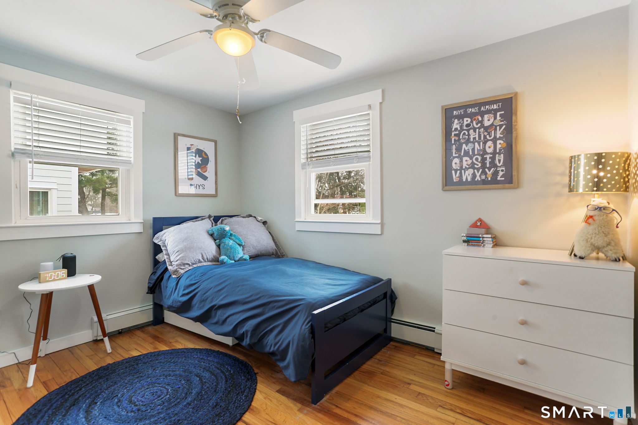 1353 Mill Plain Road Fairfield, CT 06824 - Photo 16 of 37 a bedroom with a bed and a chandelier