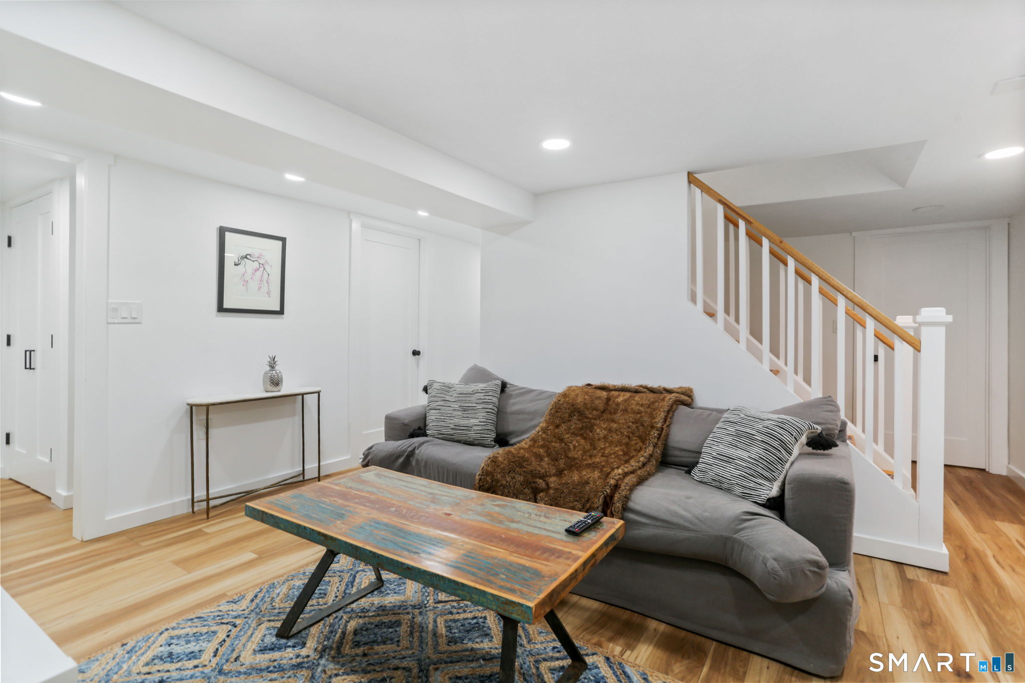 1353 Mill Plain Road Fairfield, CT 06824 - Photo 19 of 37 a living room with furniture and a wooden floor