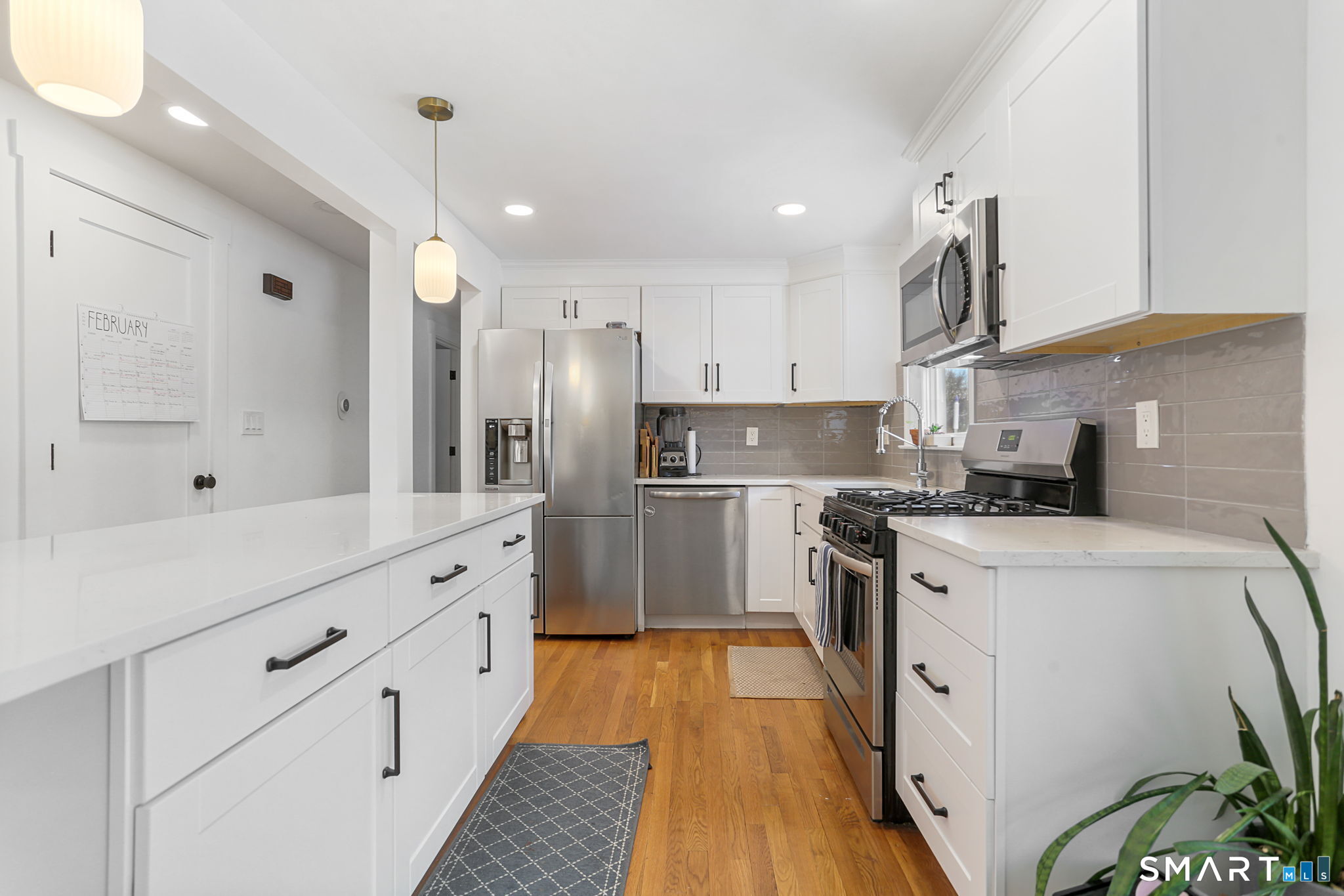 1353 Mill Plain Road Fairfield, CT 06824 - Photo 2 of 37 a kitchen with white cabinets stainless steel appliances and sink