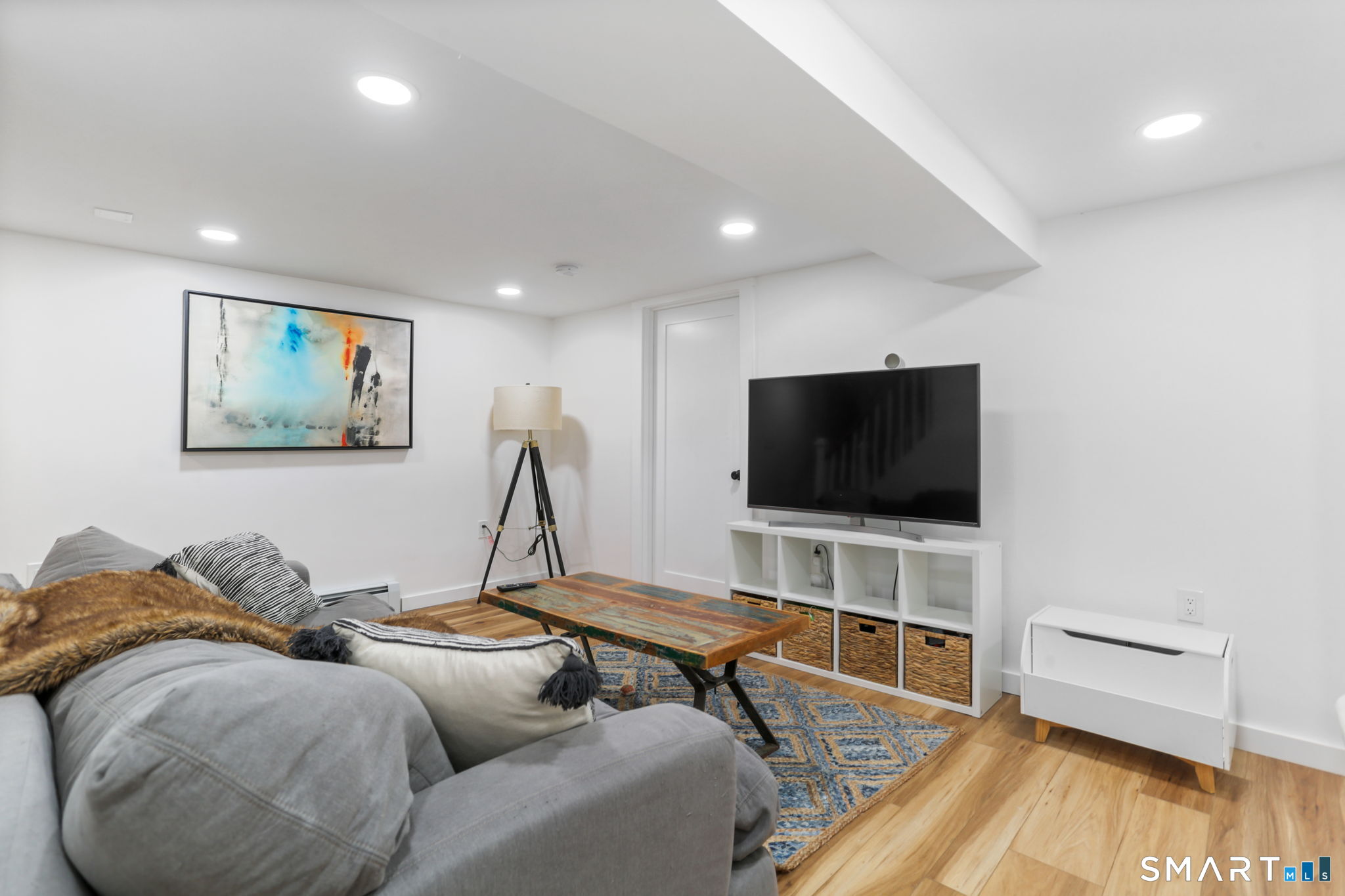 1353 Mill Plain Road Fairfield, CT 06824 - Photo 22 of 37 a living room with furniture and a flat screen tv