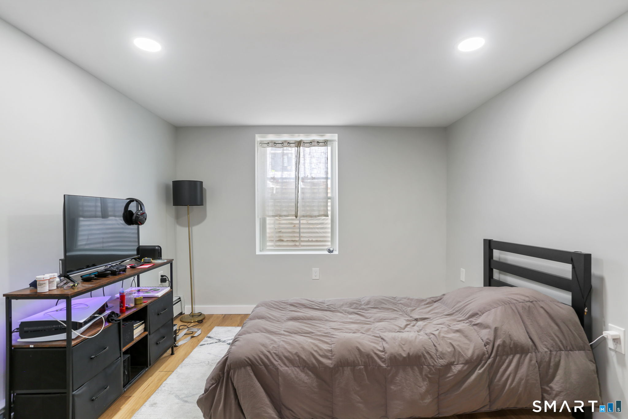 1353 Mill Plain Road Fairfield, CT 06824 - Photo 23 of 37 a bedroom with a bed and a flat screen tv