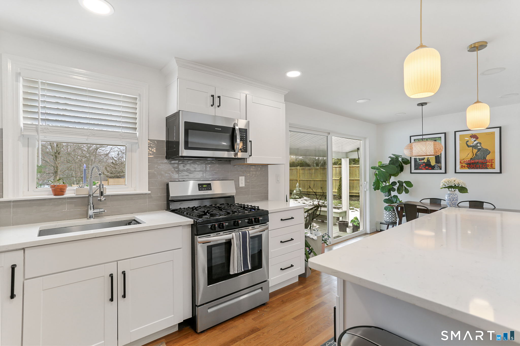 1353 Mill Plain Road Fairfield, CT 06824 - Photo 4 of 37 a kitchen with a sink stove and microwave