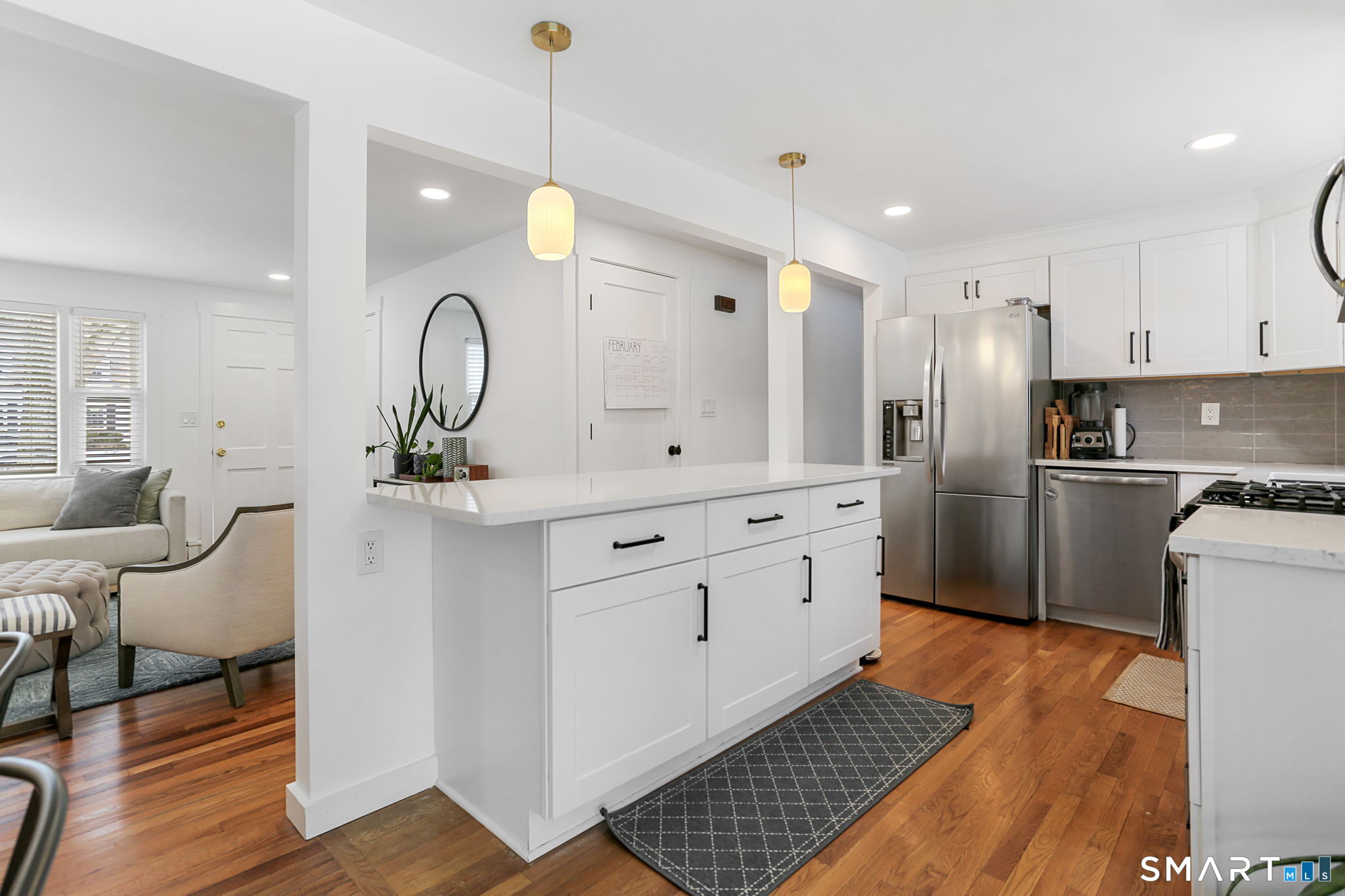 1353 Mill Plain Road Fairfield, CT 06824 - Photo 5 of 37 a kitchen with white cabinets and stainless steel appliances