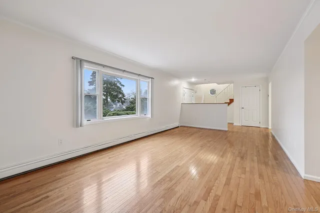 a view of an empty room and wooden floor