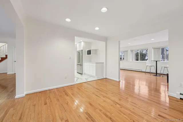 a view of a kitchen with wooden floor and a kitchen