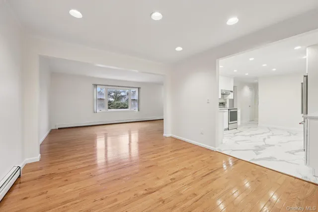 a view of kitchen and hall with wooden floor
