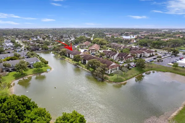 an aerial view of a city with lots of residential buildings lake and ocean view