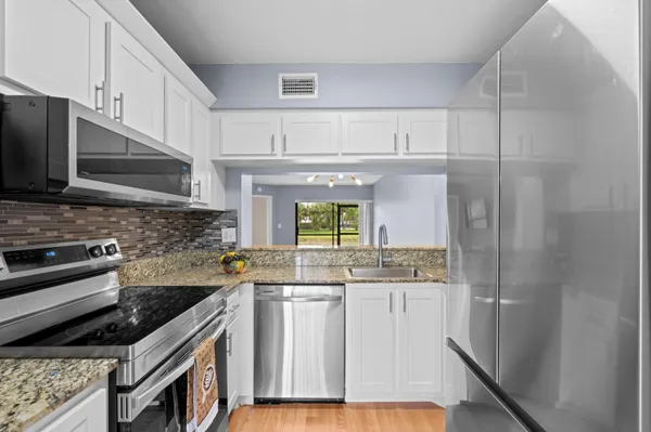 a kitchen with a sink stove and refrigerator