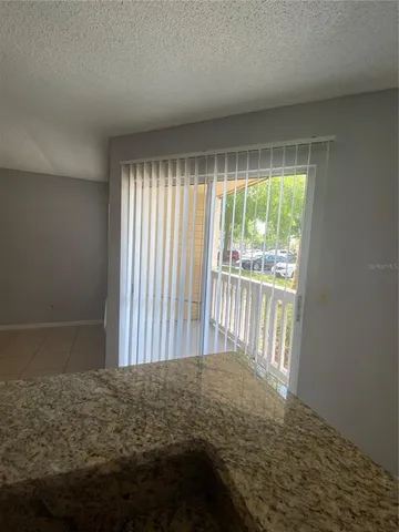 a kitchen with kitchen island granite countertop a refrigerator and a sink