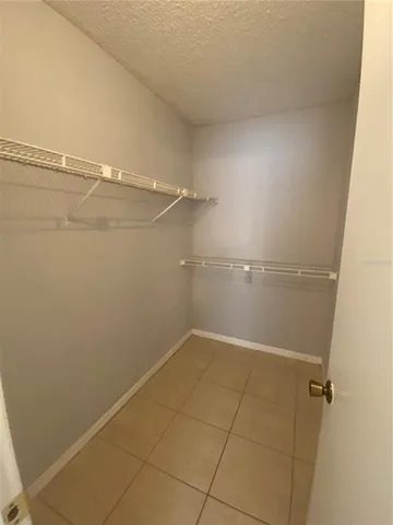 a bathroom with a granite countertop toilet sink and mirror