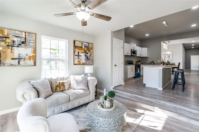 a living room with furniture and kitchen view