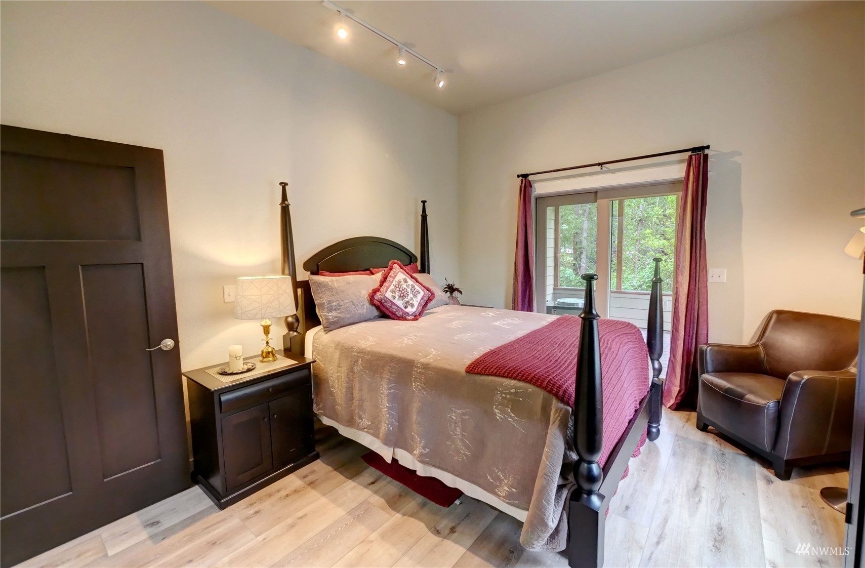 155 Twisp River Road Twisp, WA 98856 - Photo 15 of 39 a bedroom with a bed and wooden floor