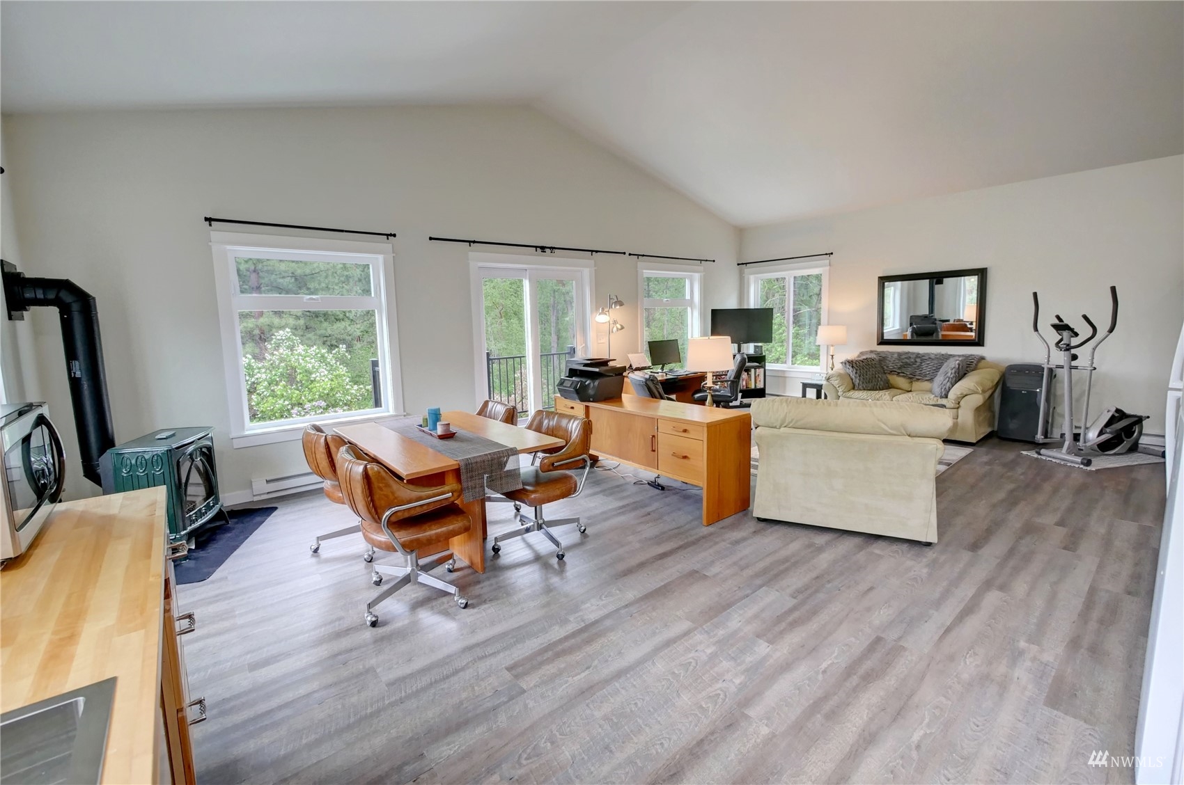 155 Twisp River Road Twisp, WA 98856 - Photo 29 of 39 a living room with furniture flat screen tv and a large window