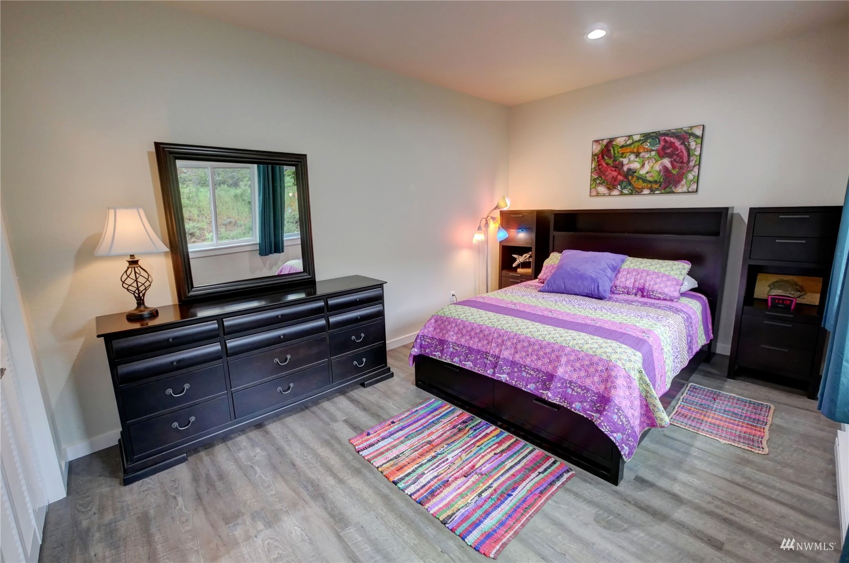 155 Twisp River Road Twisp, WA 98856 - Photo 32 of 39 a bedroom with a bed and a lamp on dresser