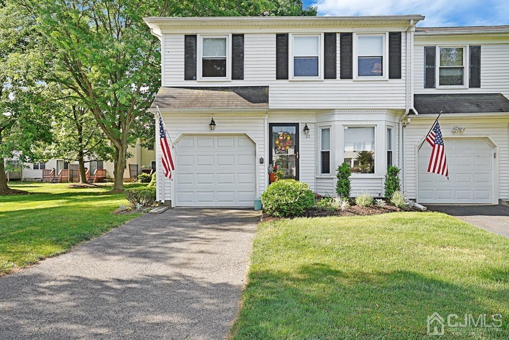 a front view of a house with a yard and garage