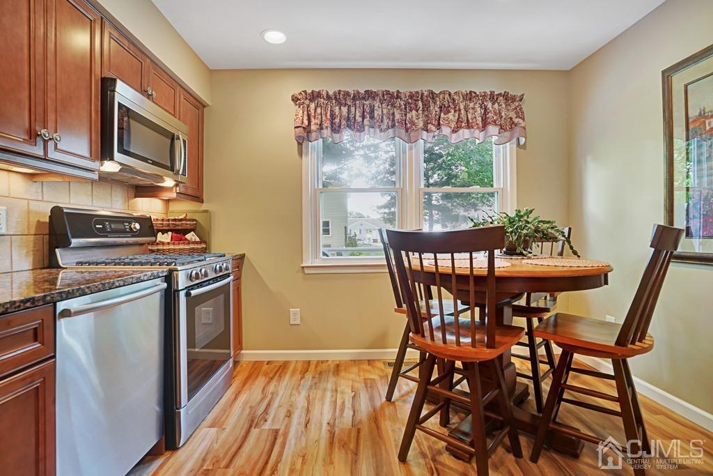 22 Hickory Court Middlesex, NJ 08846 - Photo 11 of 26 a dining room with furniture a window and wooden floor