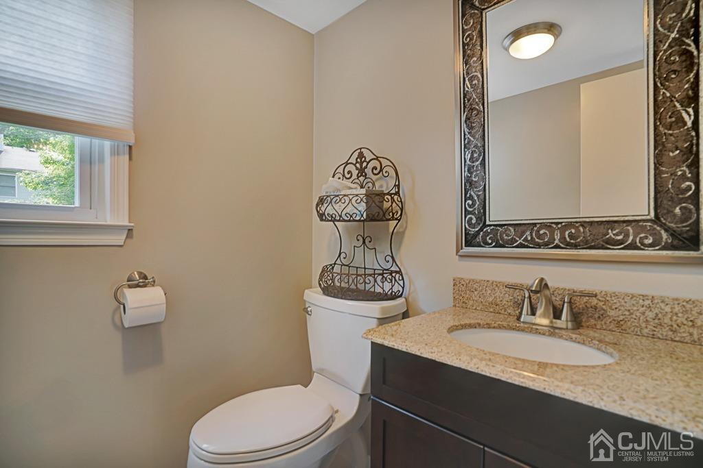 22 Hickory Court Middlesex, NJ 08846 - Photo 12 of 26 a bathroom with a granite countertop toilet sink and mirror