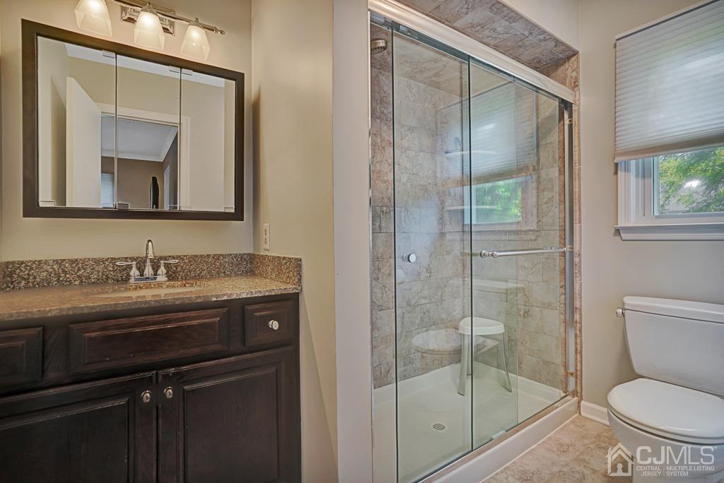 22 Hickory Court Middlesex, NJ 08846 - Photo 17 of 26 a bathroom with a granite countertop sink toilet and shower