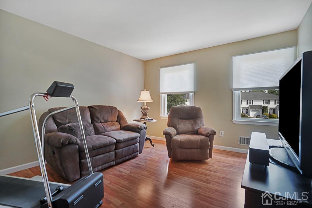 22 Hickory Court Middlesex, NJ 08846 - Photo 19 of 26 a living room with furniture and a flat screen tv