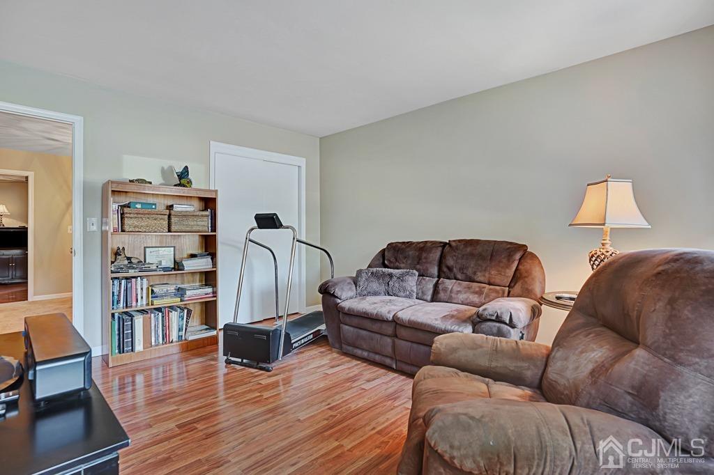 22 Hickory Court Middlesex, NJ 08846 - Photo 20 of 26 a living room with furniture a walk in closet and a book shelf