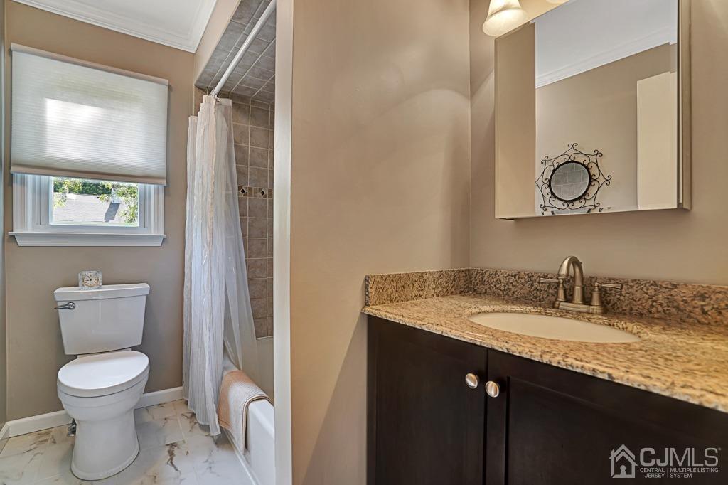 22 Hickory Court Middlesex, NJ 08846 - Photo 21 of 26 a bathroom with a granite countertop toilet sink and mirror