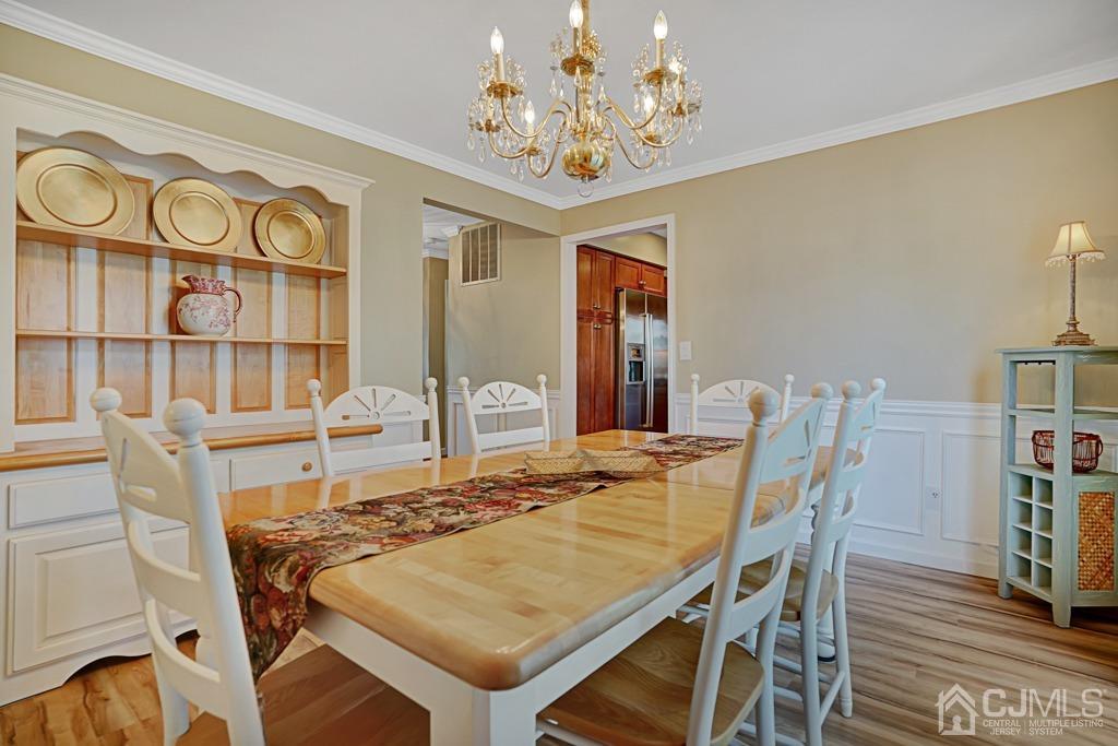 22 Hickory Court Middlesex, NJ 08846 - Photo 7 of 26 a view of a dining room with furniture and chandelier