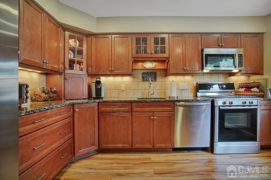 22 Hickory Court Middlesex, NJ 08846 - Photo 8 of 26 a kitchen with stainless steel appliances granite countertop a stove a sink and a microwave