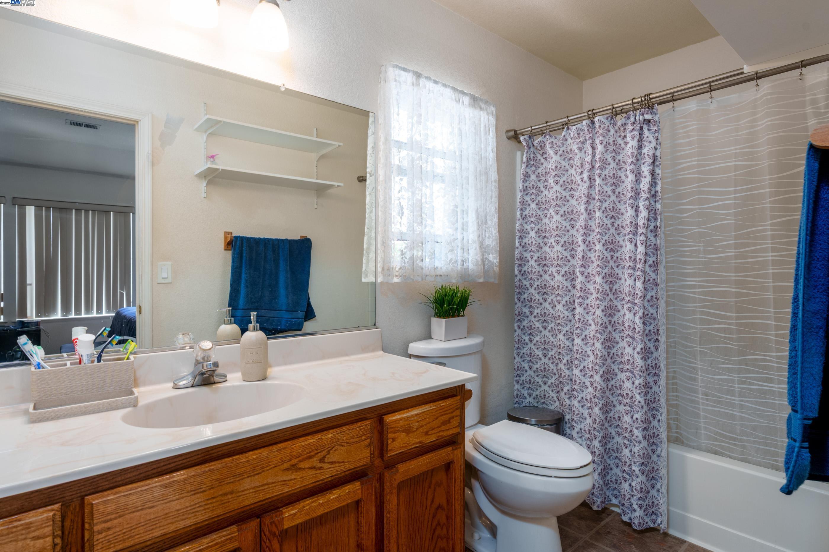 7691 Church Street, Unit B Gilroy, CA 95020 - Photo 11 of 27 a bathroom with a sink toilet and shower