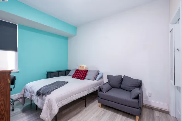 a kitchen with stainless steel appliances a white stove top oven a sink a refrigerator and a window