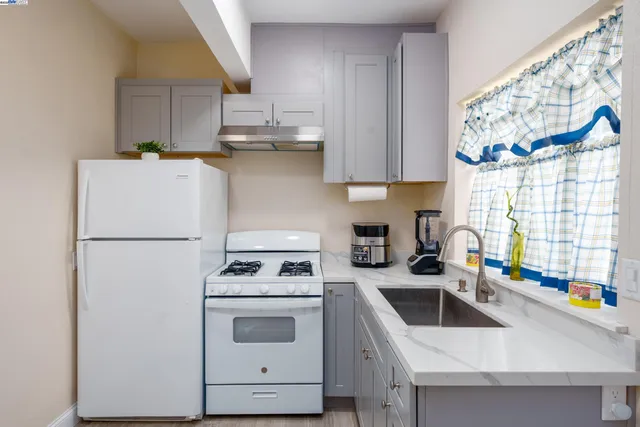 a kitchen with stainless steel appliances granite countertop a stove and a refrigerator