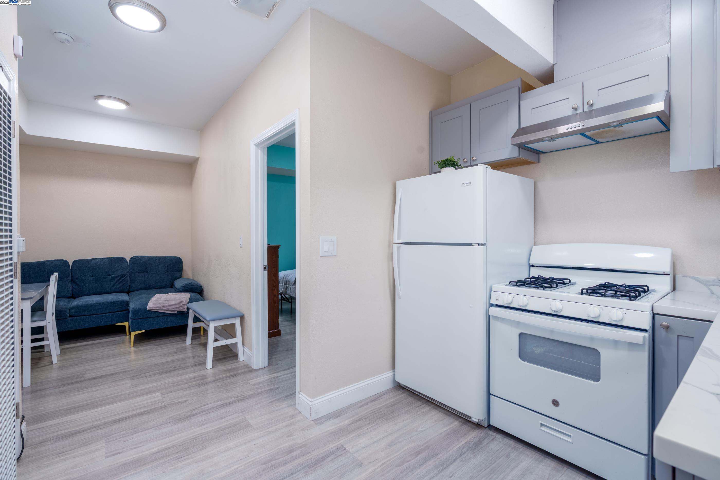 7691 Church Street, Unit B Gilroy, CA 95020 - Photo 25 of 27 a kitchen with a refrigerator and a stove top oven
