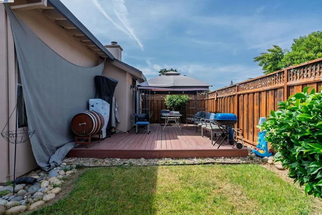 a view of a backyard with plants and outdoor seating