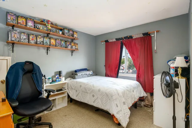 a bedroom with a bed chair and a window