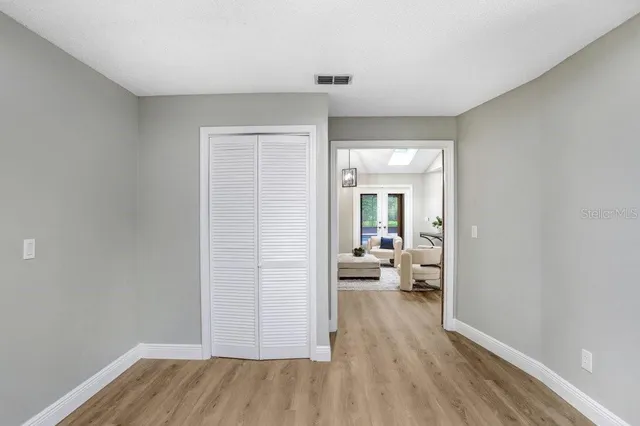 a bedroom with a large bed couch and a window