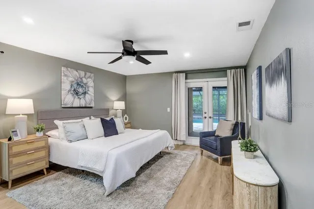 a bedroom with a bed and a chandelier