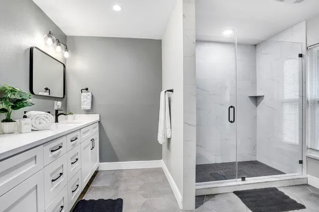 a bathroom with a sink vanity and a mirror