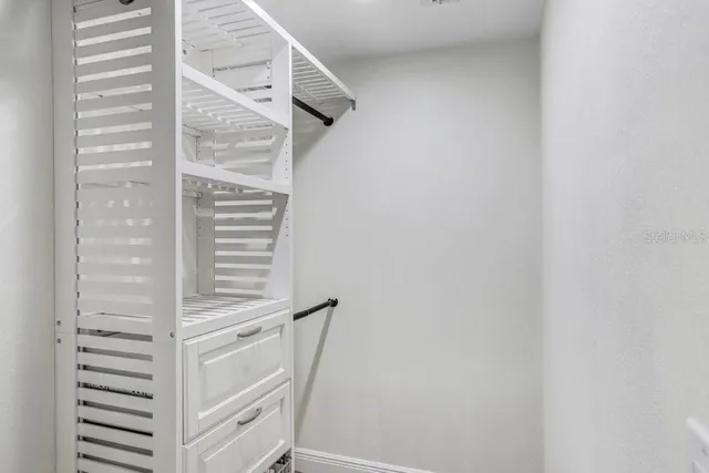 a kitchen with kitchen island white cabinets and appliances